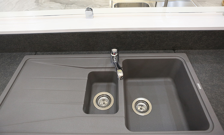 Composite sink with dark grey worktop. 