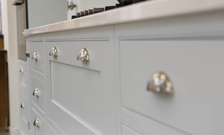 Vintage style cup handles on traditional style baby blue kitchen cabinets 