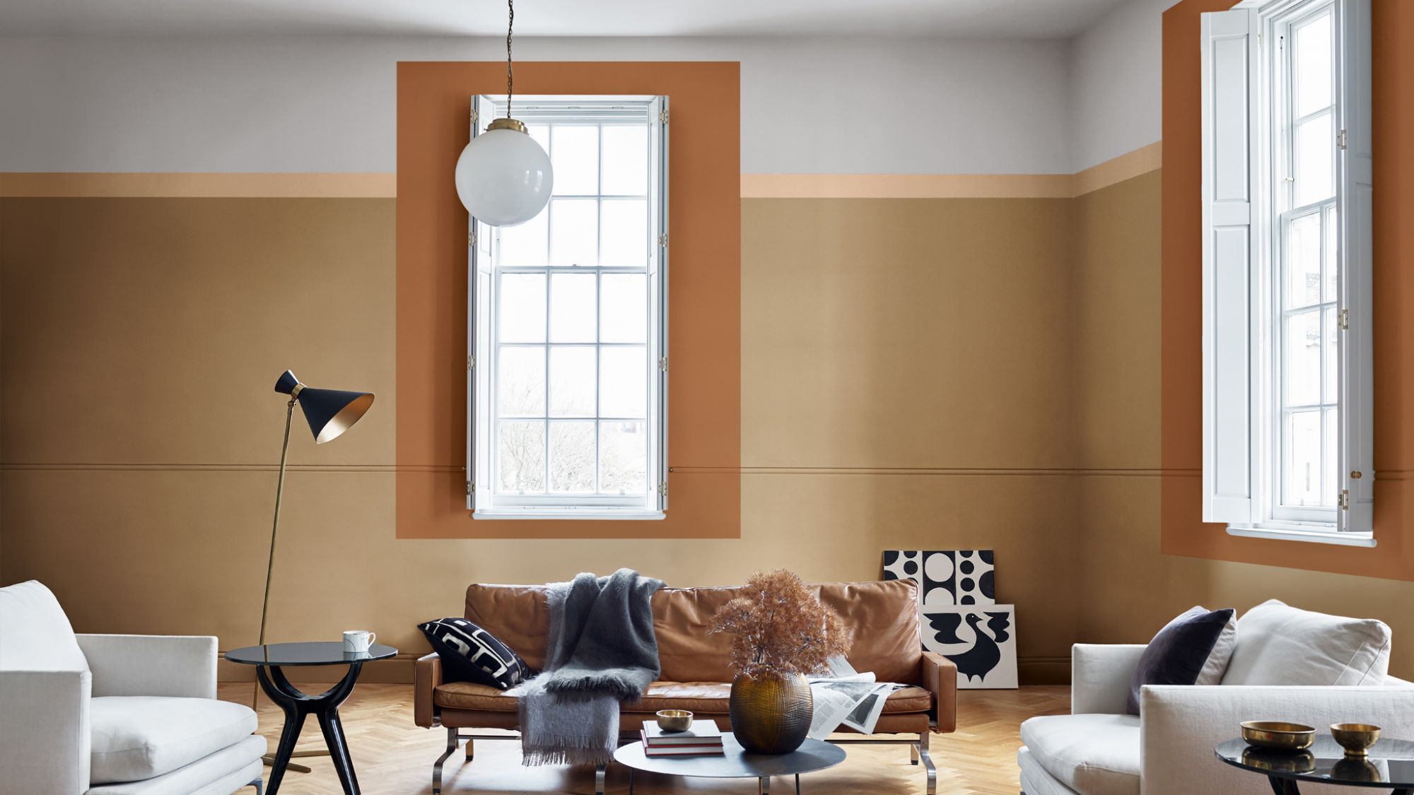 A living room with large windows and Spiced Honey coloured walls