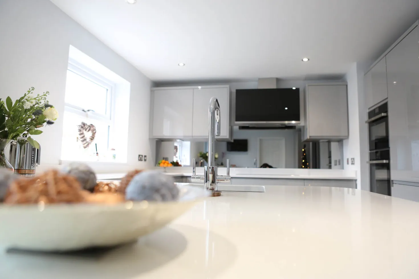 Smoked Mirror Splashback and Gleaming White Worktops image