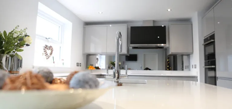 Smoked Mirror Splashback and Gleaming White Worktops image