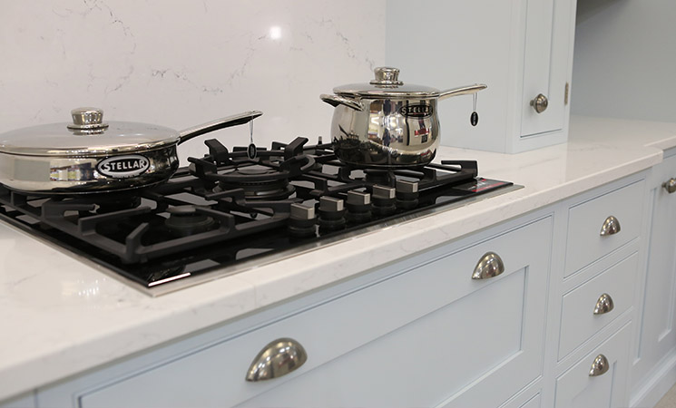 Gas hob in baby blue fitted kitchen