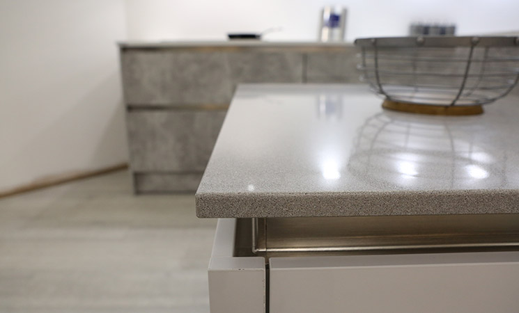Grey Quartz Kitchen Worktop with textured grey kitchen cabinets 