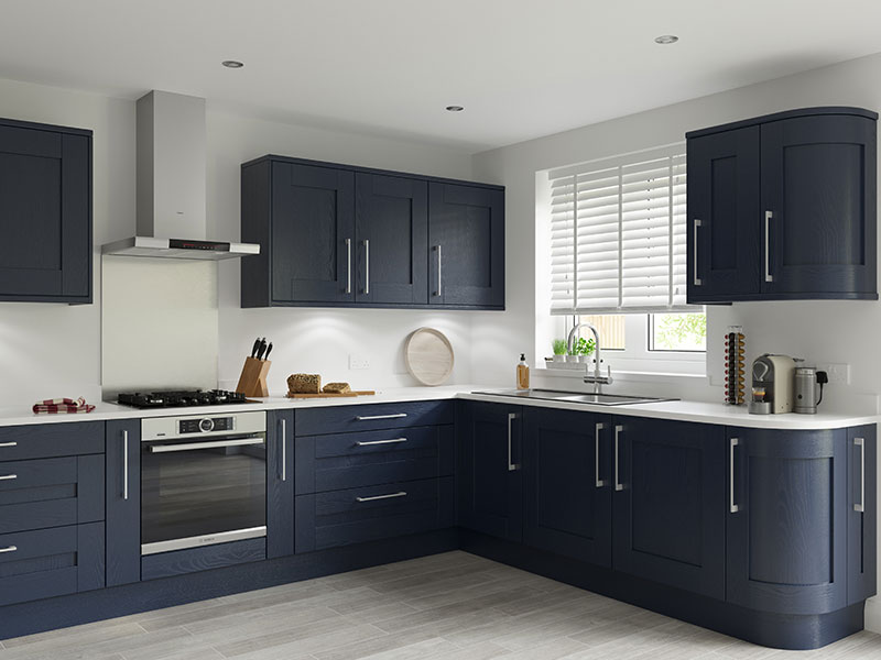 A kitchen with dark blue statement cabinets and bright white walls 