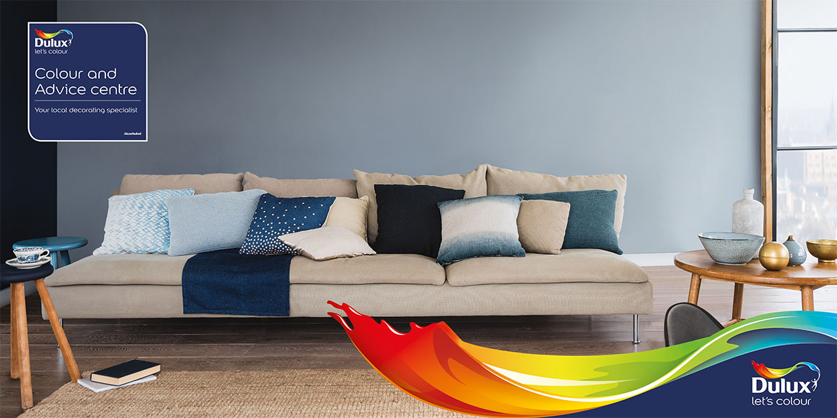 Image of Sofa with a Painted Wall behind and the Dulux logo