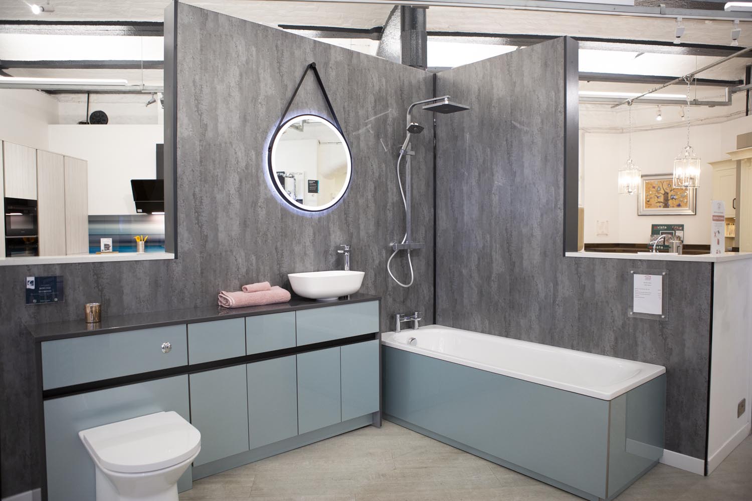 Calypso bathroom in aqua colour cabinetry against grey shower panel