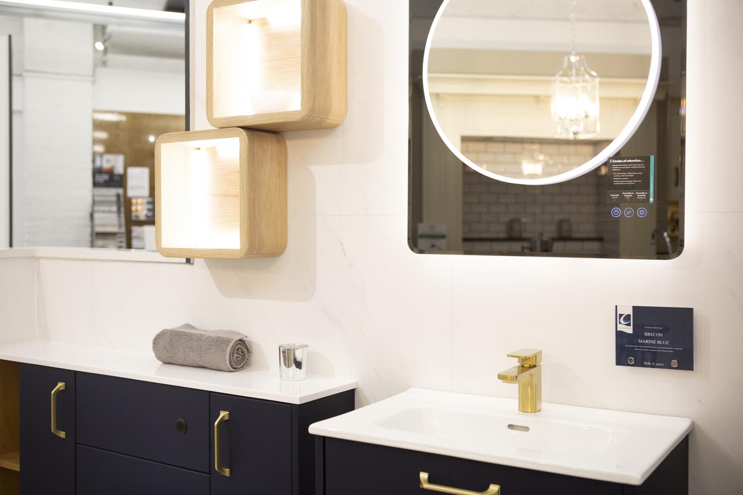 Navy cabinetry and brass tap fitting bathroom display