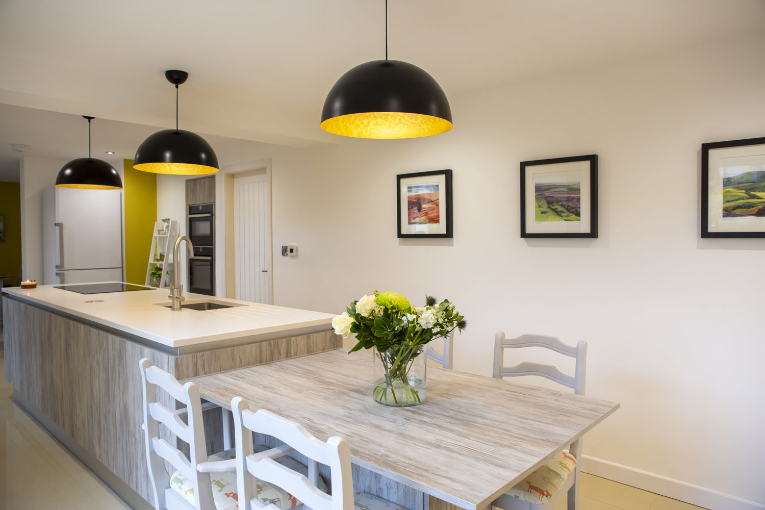 Crown handleless kitchen with dining table extension on kitchen island