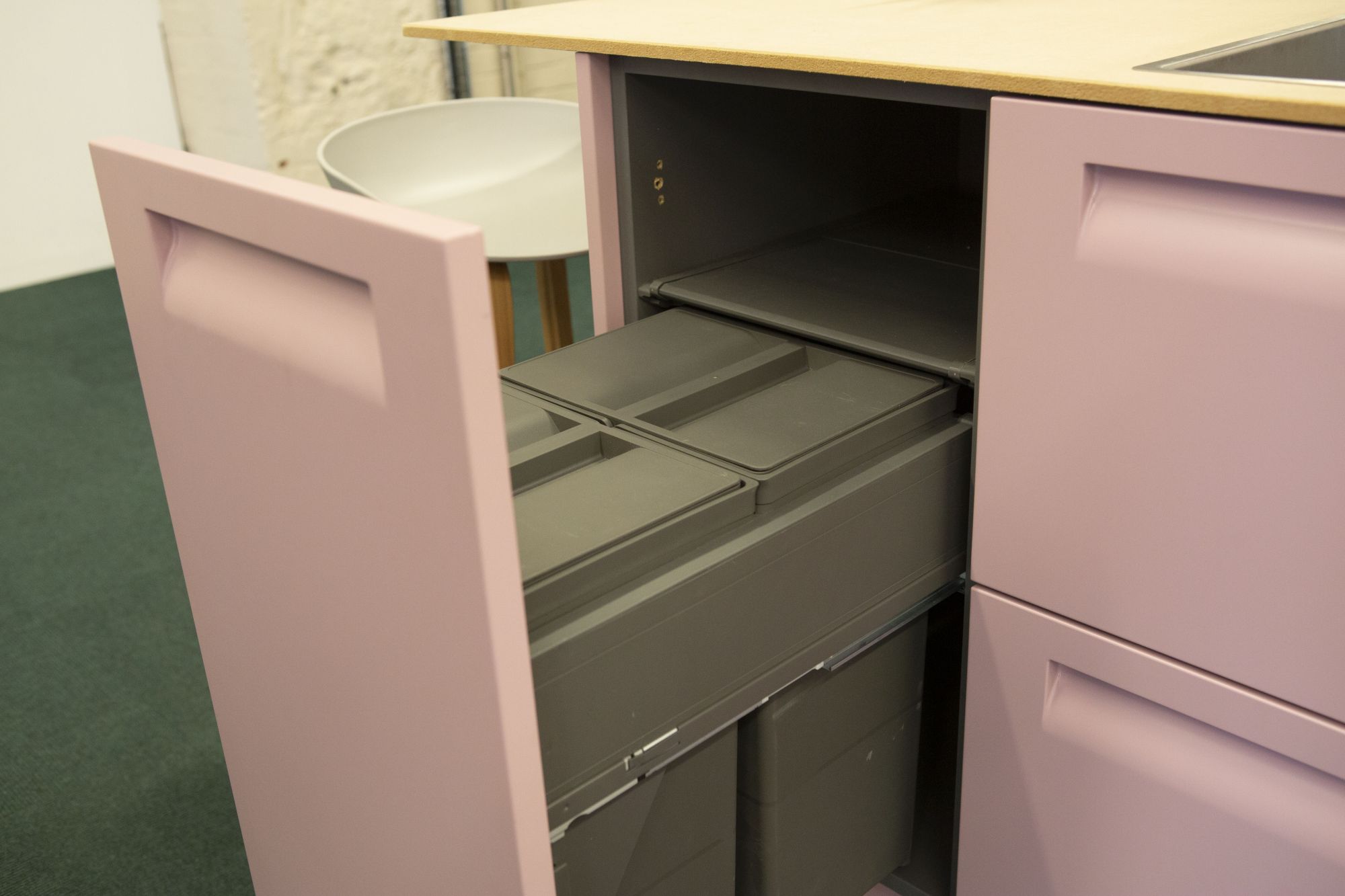 Pink cupboard with built - in recycling