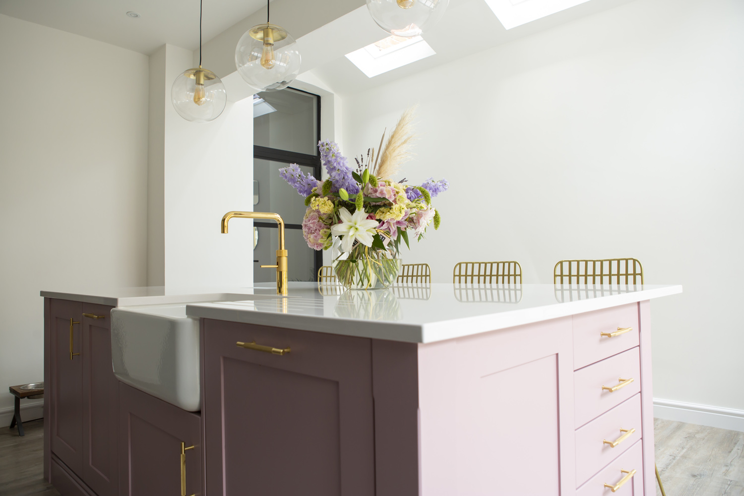 A dusky pink kitchen island from Stoneham Kitchens and Gardiner Haskins Interiors