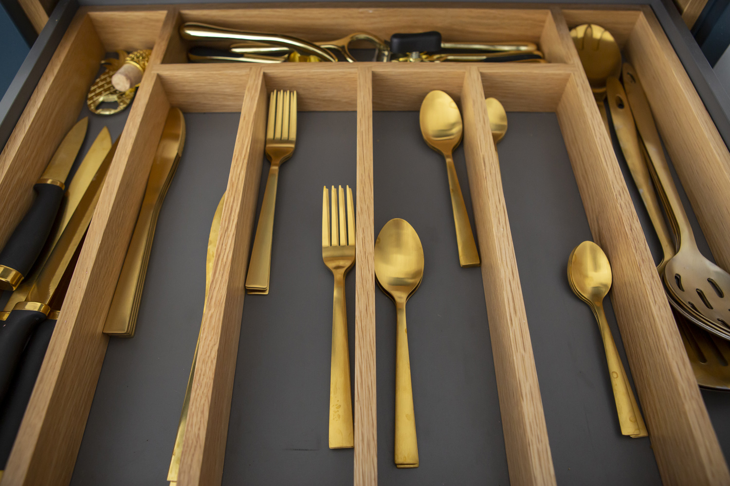 Aesthetic kitchen drawer with oak detail and gold cutlery