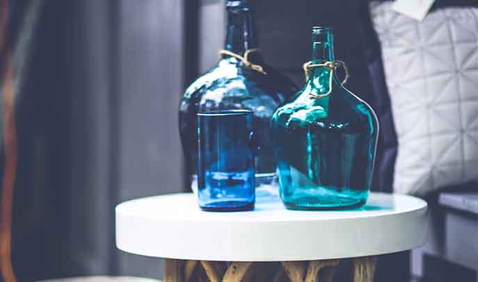 Scandi bedside table with gorgeous blue jewel colour glass vases 