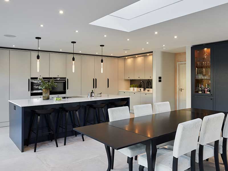 Stoneham Kitchen featuring light cabinetry and dark kitchen island.