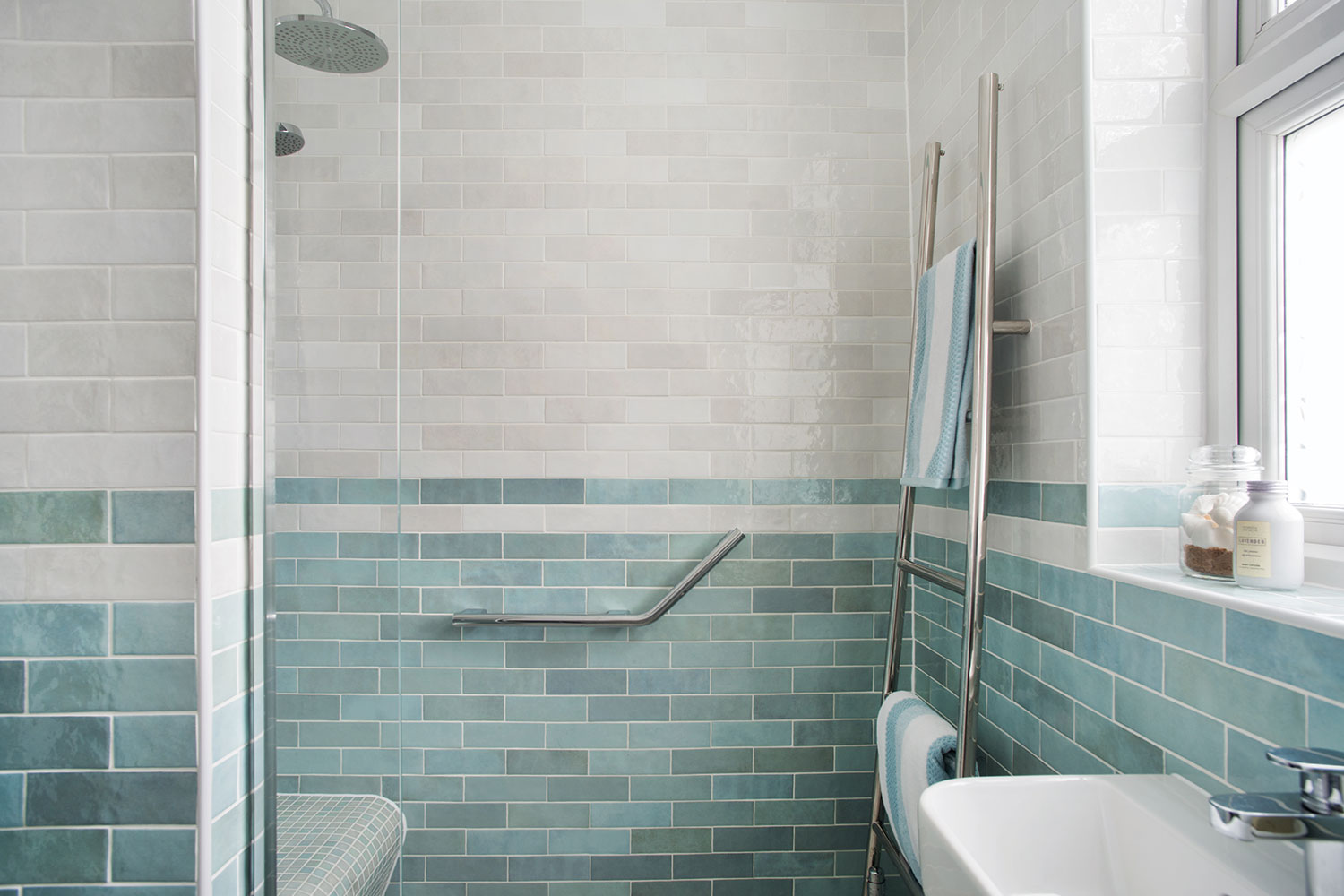 A walk in shower with grab rail for easy accessibility to future proof the couple's home.