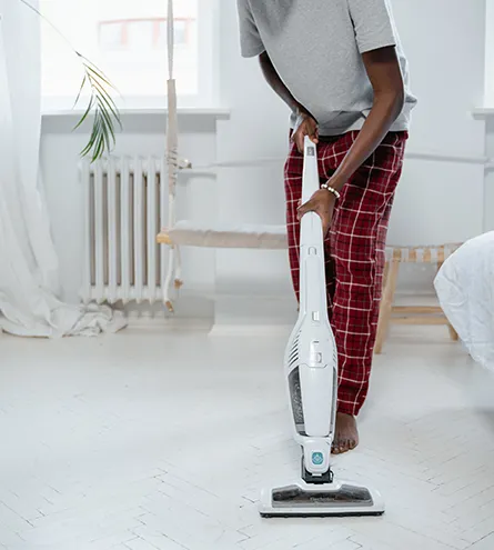 Person hoovering floor